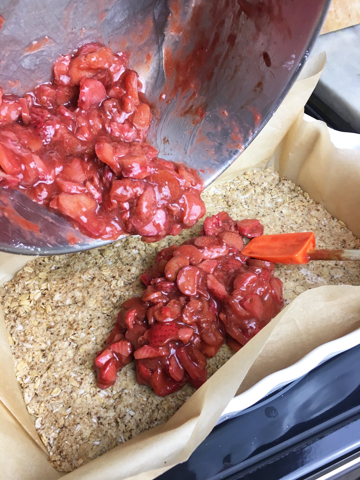 Strawberry rhubarb mixture putting on top of baked crust. 