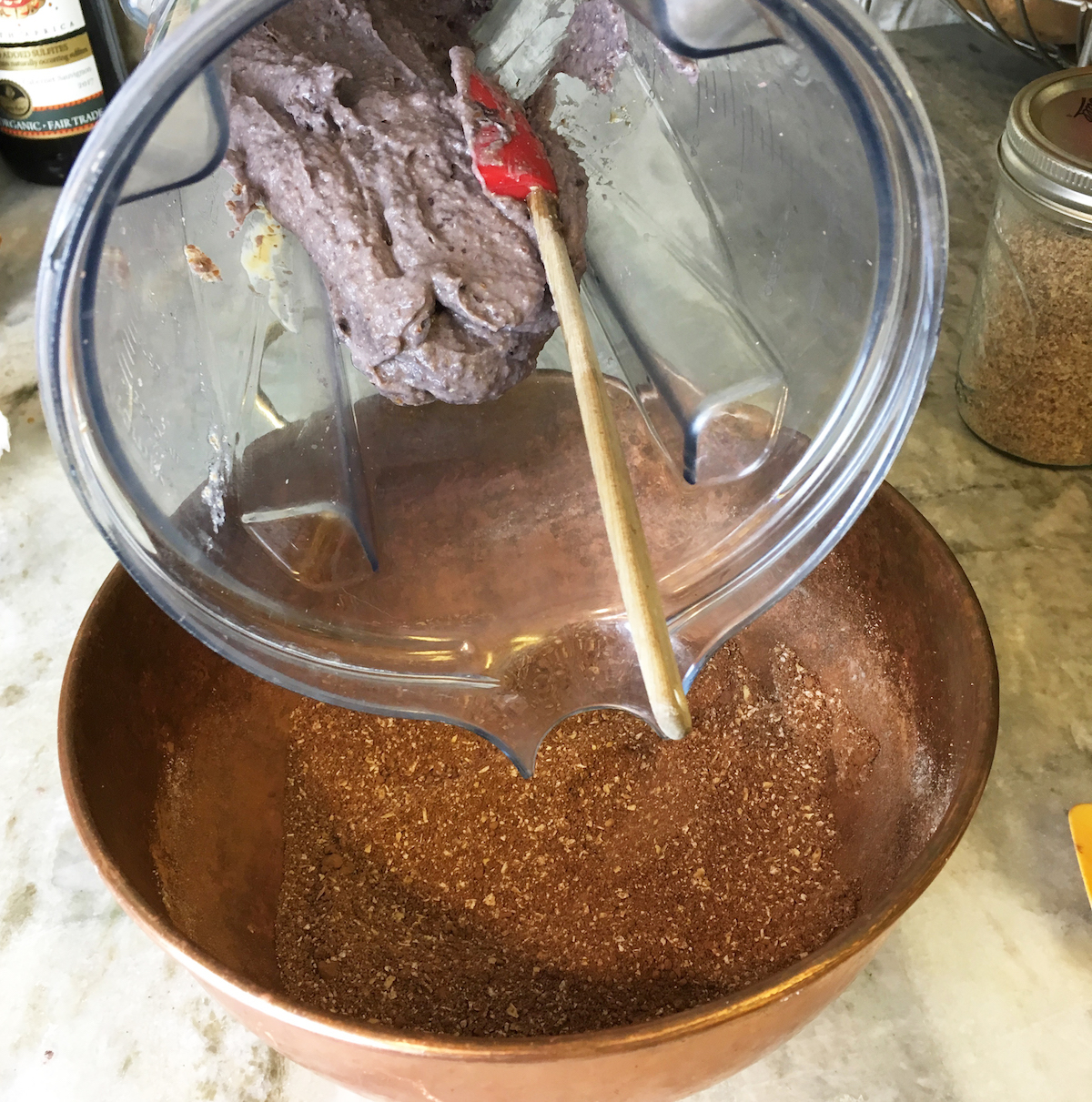 Mixing the wet and dry ingredients together! The wet ingredients will probably look purple, but they won't once mixed with the dry.