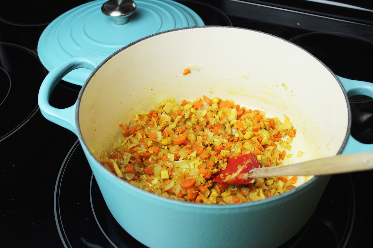 Sauteing onions, garlic, ginger, carrots, and spices for the dal.