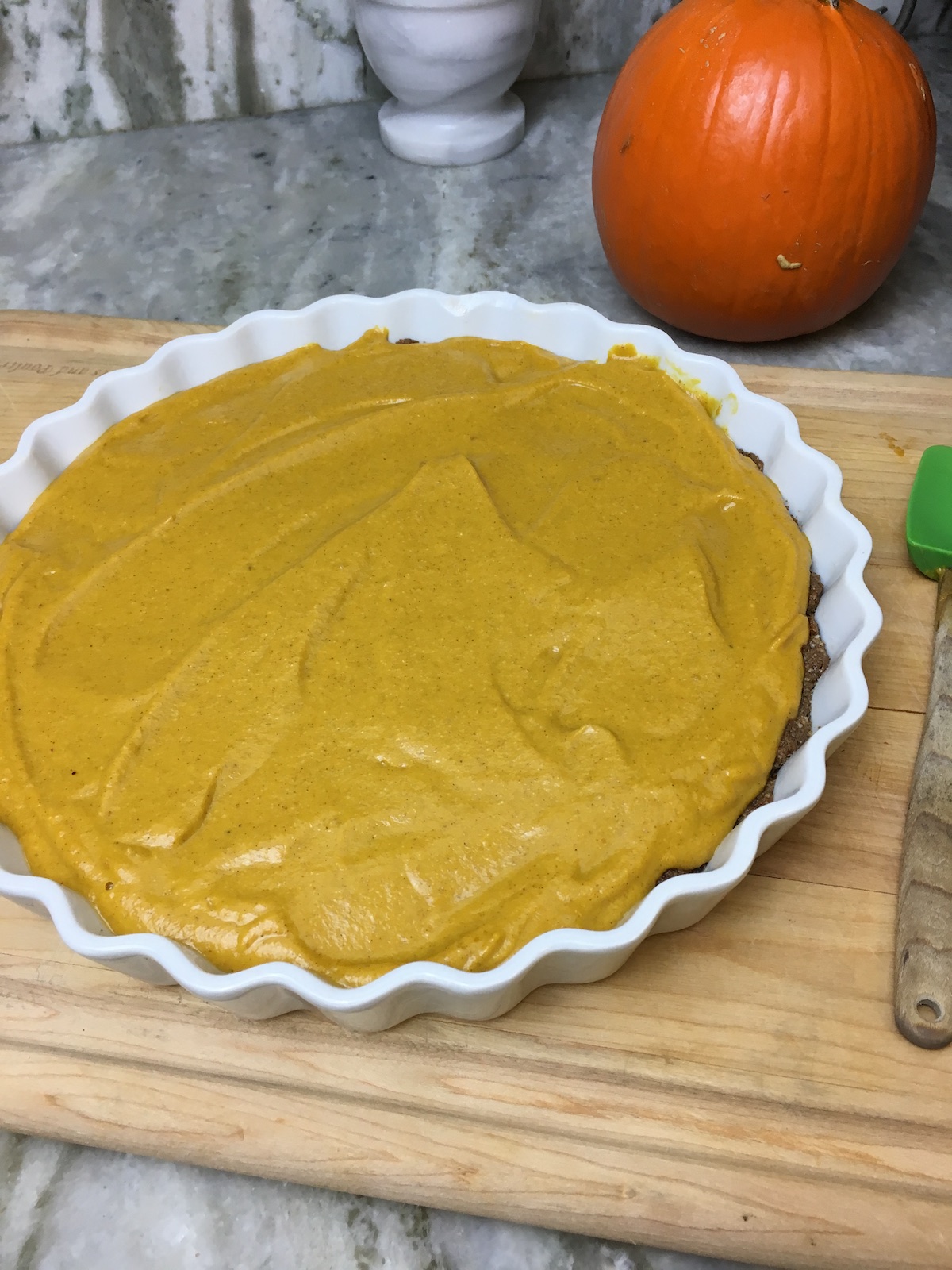 After the crust has baked for 10 mins, smooth pumpkin filling on top.